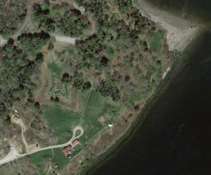 Aerial view of Cape Jellison's Fort Point, where Fort Pownal was located. The star shape fort remains can still be clearly seen. 